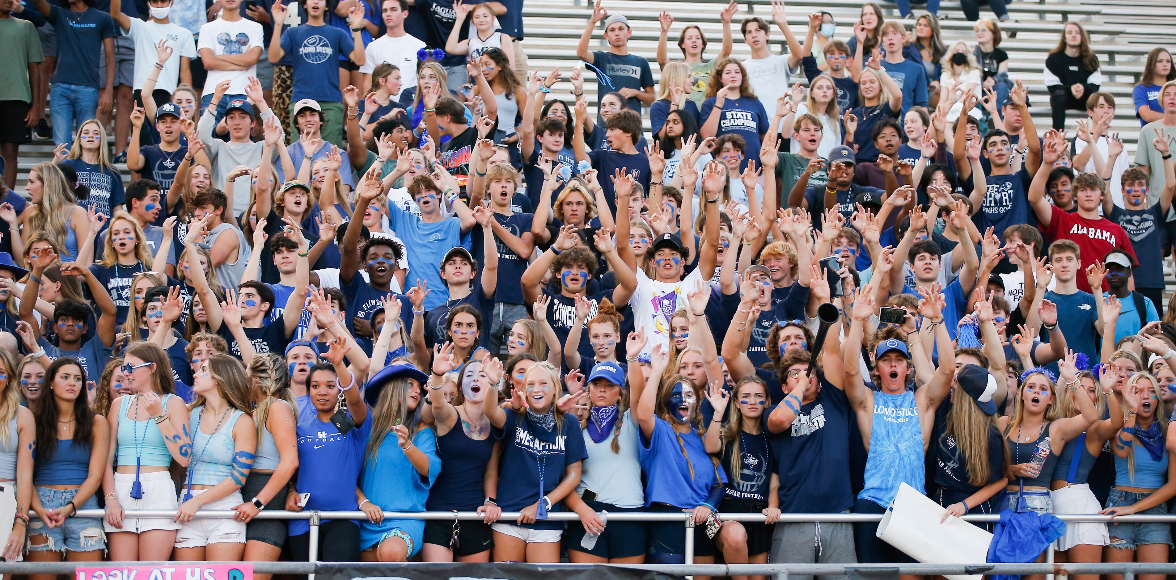 Flower Mound football fans cheer for their team during the first half of a high school...