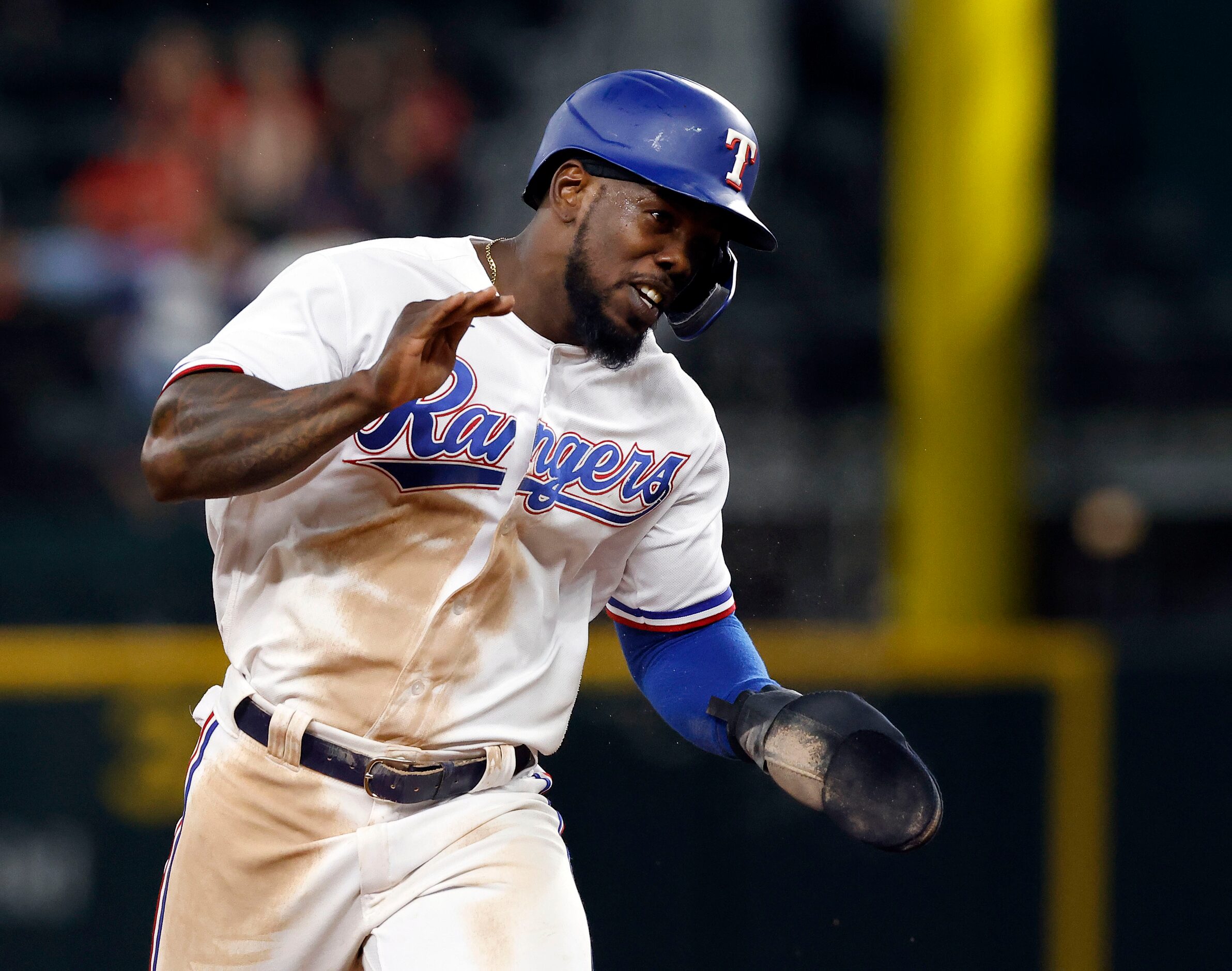 As he rounds second base, Texas Rangers Jose Trevino reacts after Adolis Garcia hit a...