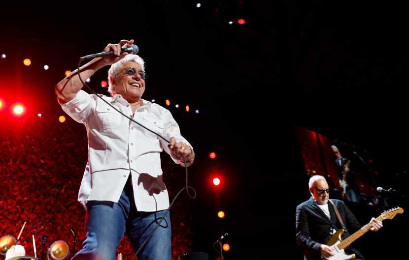 Roger Daltrey, left, whips a mic cord as Pete Townshend accompanies him on guitar. Daltrey...