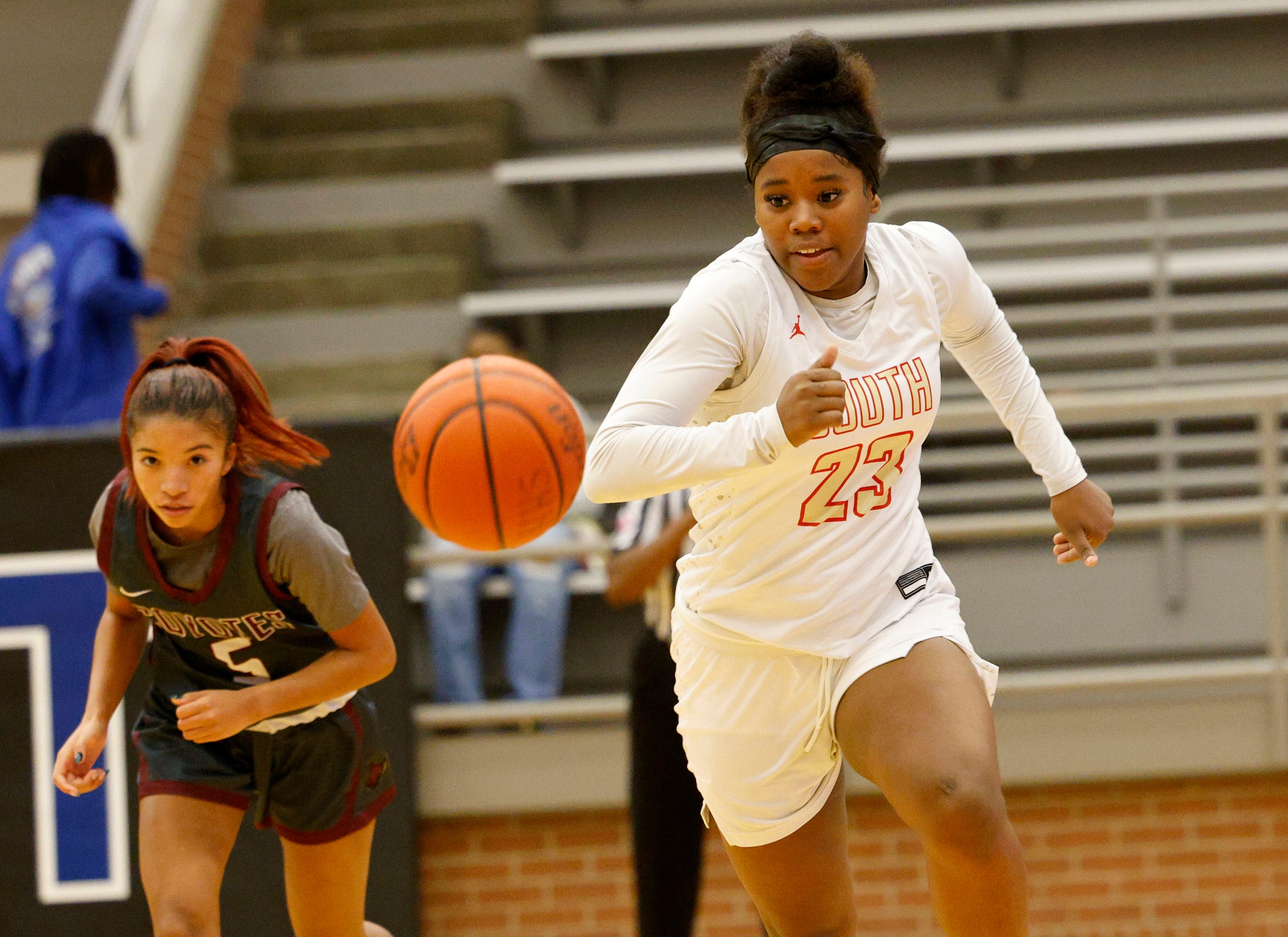 South Grand Prairie's Janae Johnson (23) and Frisco Heritage's Royal Crooks (5) go to get a...