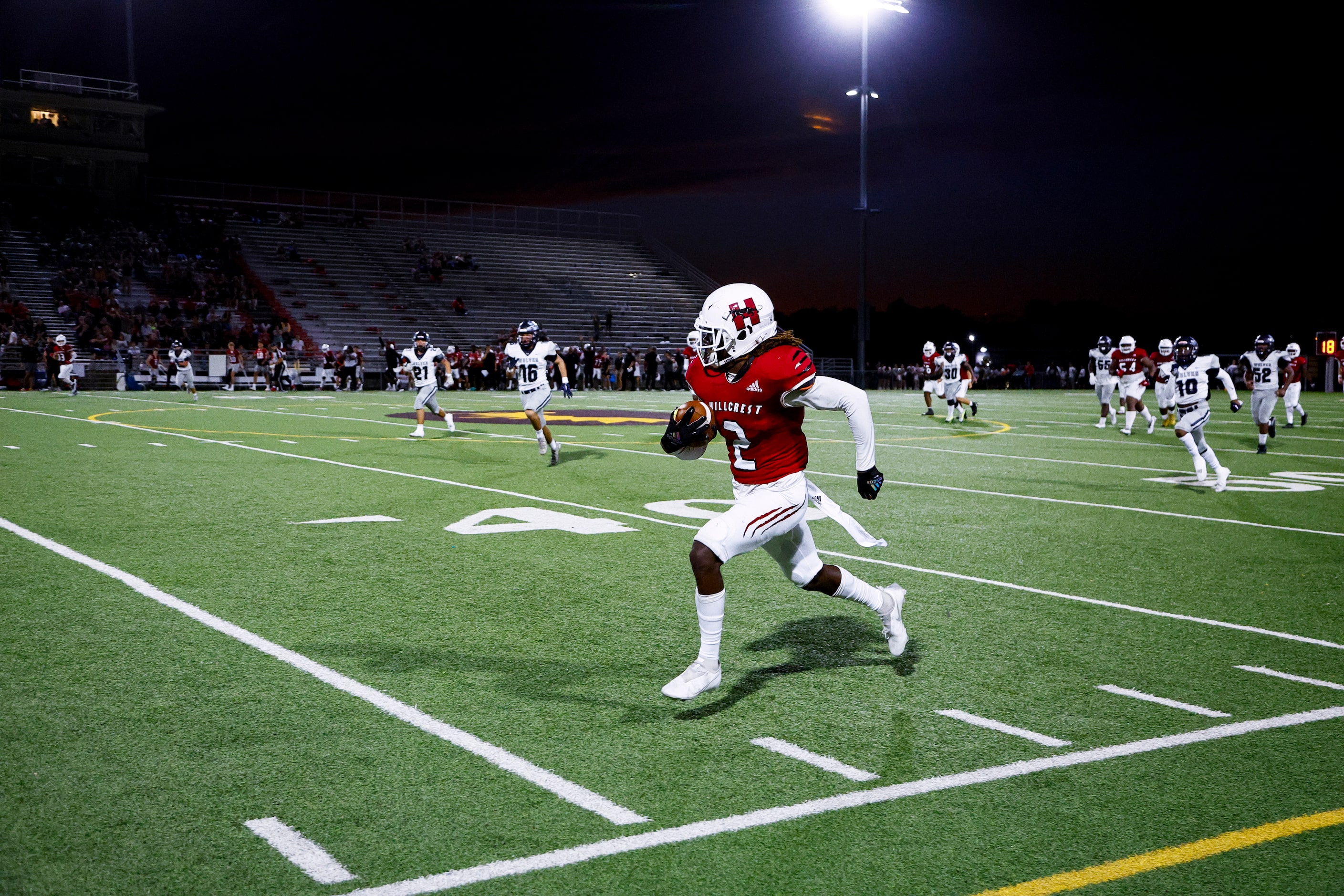 Hillcrest senior wide receiver Reggie Williams (2) looks for room against the Carrollton...