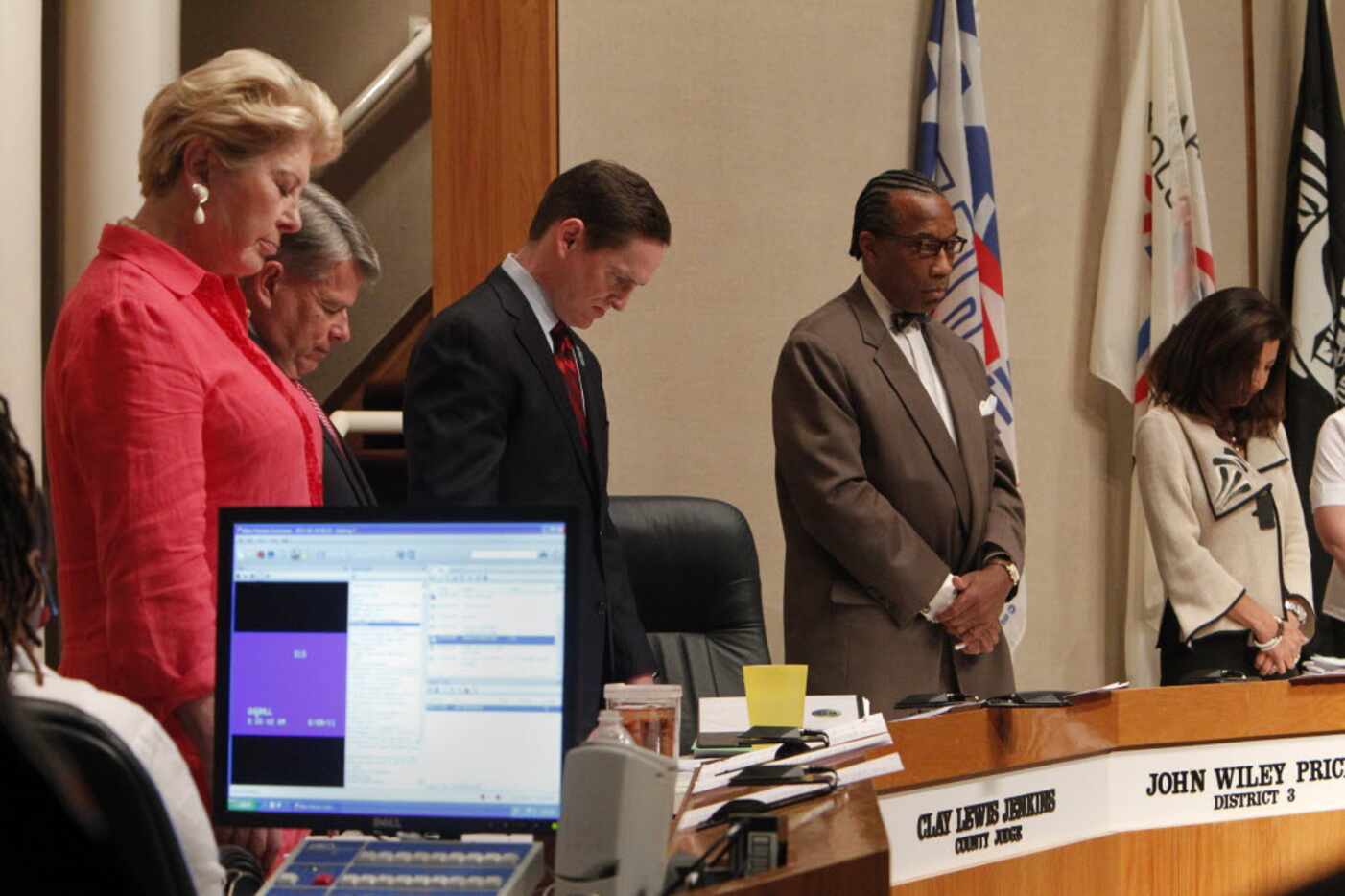 Dallas County commissioners bow in prayer before the weekly meeting Tuesday, June 28, 2011...