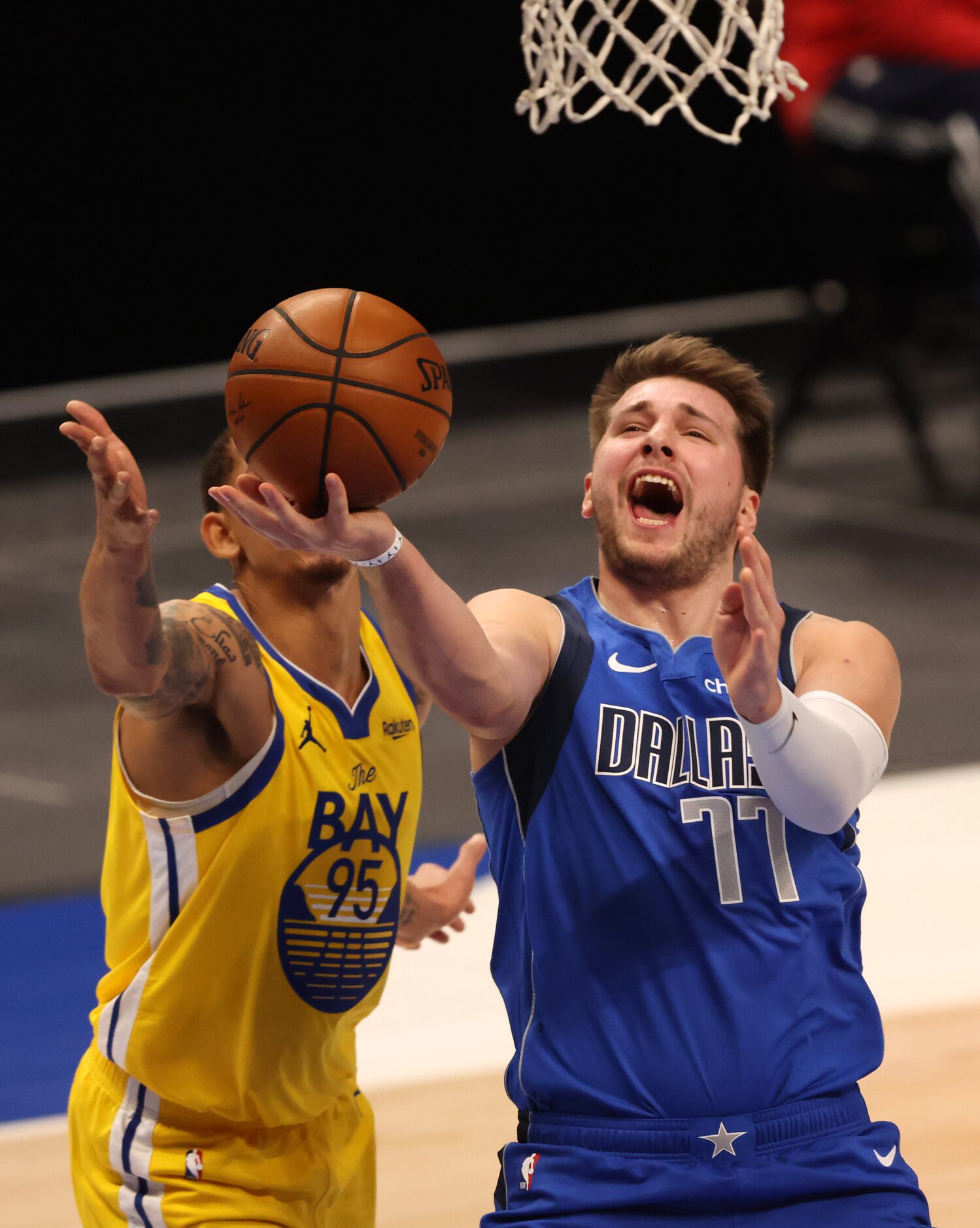 Dallas Mavericks guard Luka Doncic (77) attempts a layup in front of Golden State Warriors...