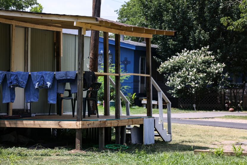 Jeans hang over the ledge on a porch at Ponderosa Mobile Home Park in Haltom City. The...