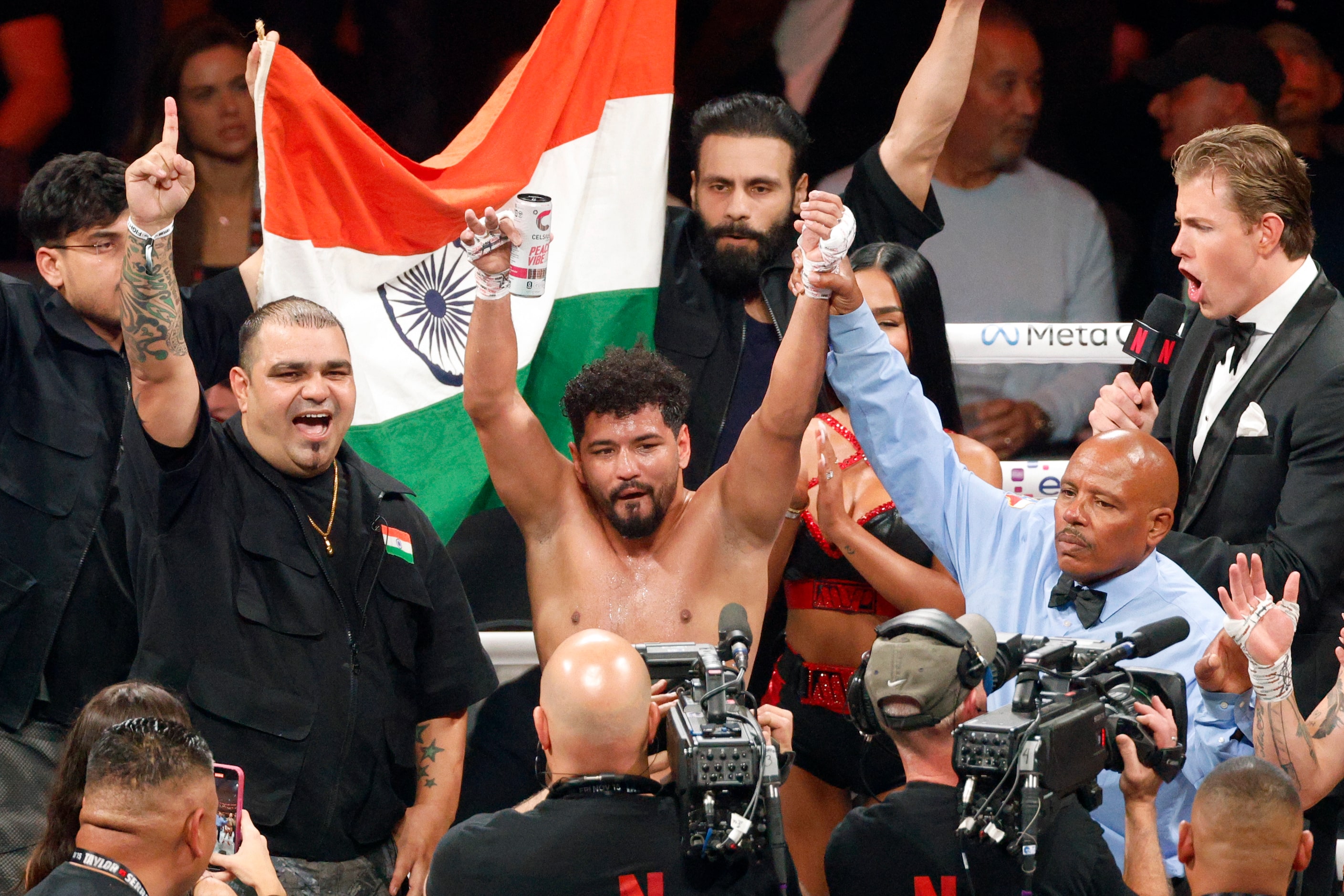 Neeraj Goyat (center) celebrates after defeating Whindersson Nunes in a super middleweight...