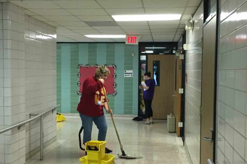 Garfield Elementary Principal Courtney Merilatt works on cleanup efforts at her Houston...