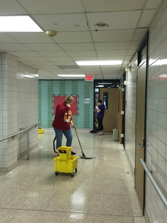 Garfield Elementary Principal Courtney Merilatt works on cleanup efforts at her Houston...