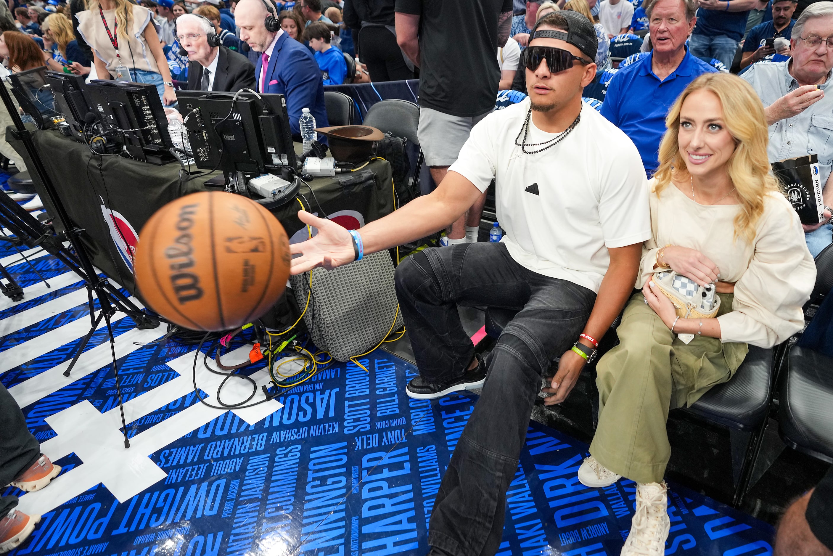 Kansas City Chiefs quarterback Patrick Mahomes tosses a ball back to the court while...