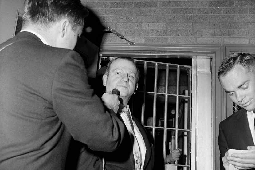 In this photos from Jan. 28, 1964, Jack Ruby talks to a reporter while being returned to...