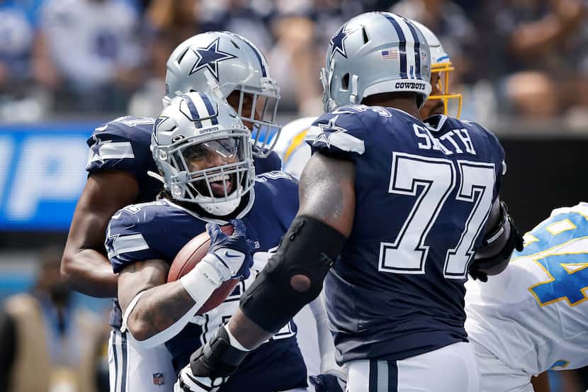 Dallas Cowboys running back Ezekiel Elliott (21) celebrates his first quarter touchdown run...