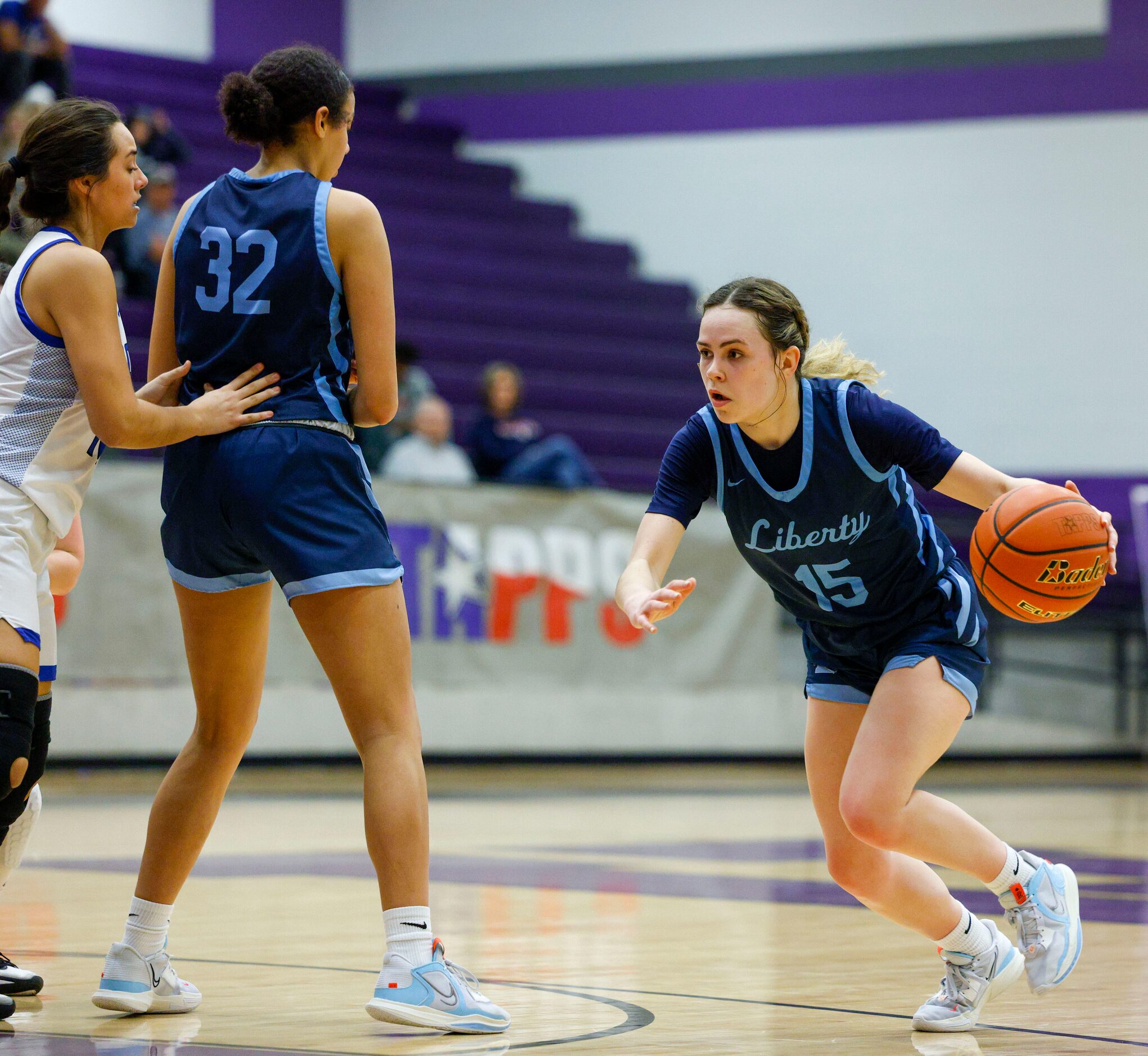 Argyle Liberty Christian guard Emma Martin (15) dribbles around a screen set by forward...