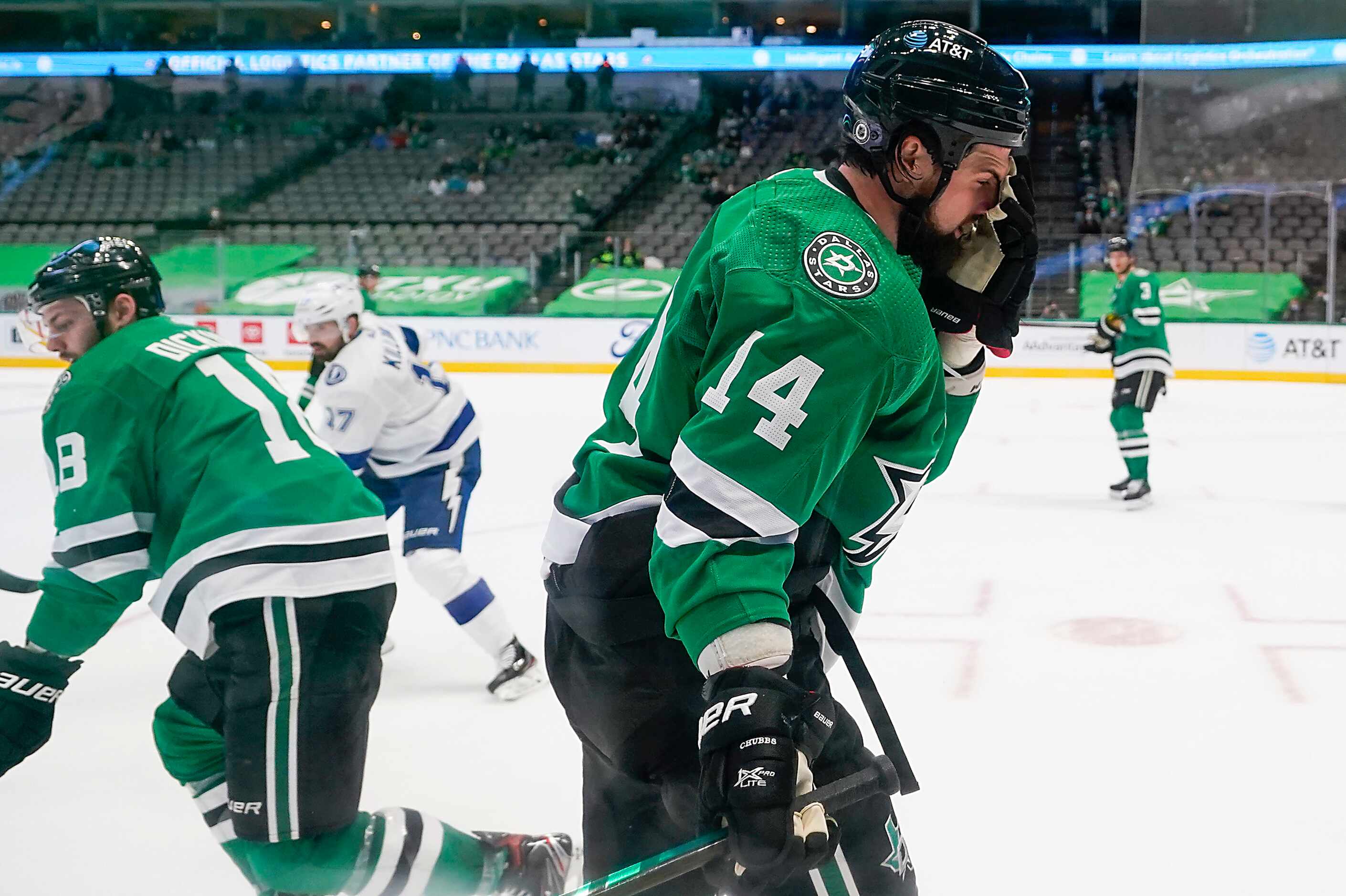 Dallas Stars left wing Jamie Benn (14) reacts after taking a stick to the face during the...