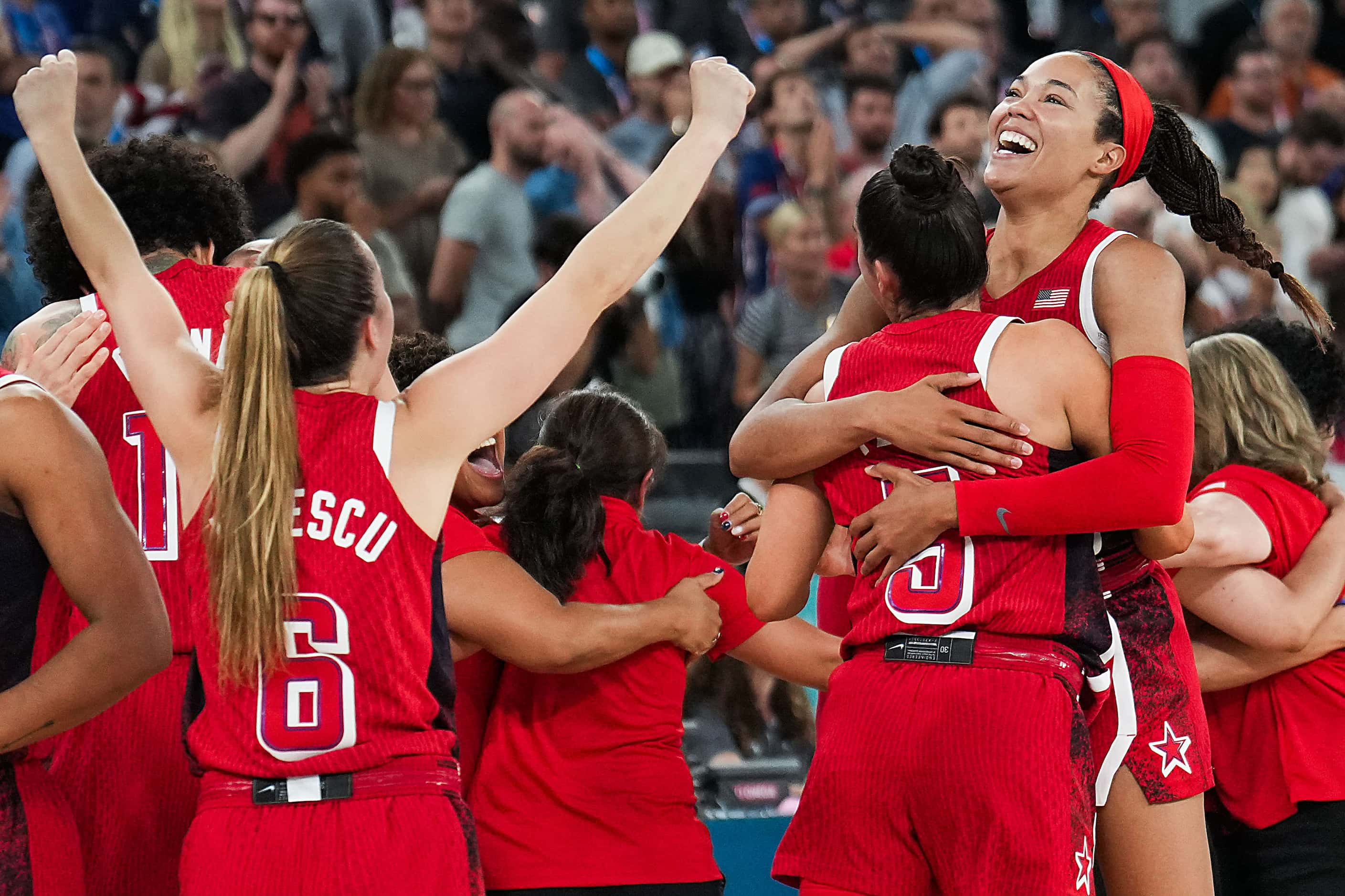 Napheesa Collier of the United States (right)  celebrates with Kelsey Plum (5) and Sabrina...