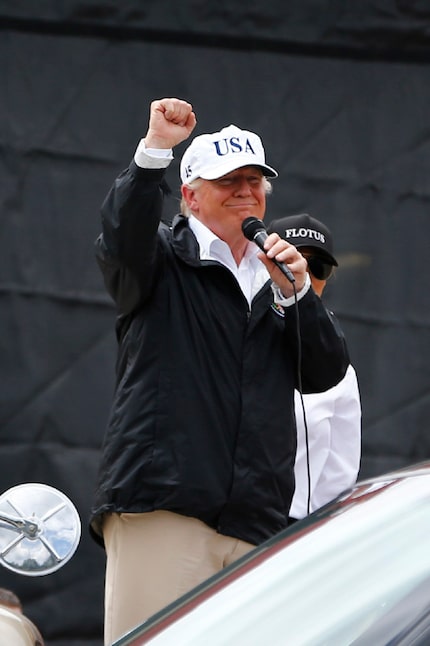 President Donald Trump waves to the crowd after attending a briefing from Federal, State and...