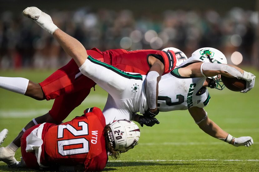 Southlake Carroll running back Owen Allen (2) is brought down by Rockwall-Heath’s Peyton...