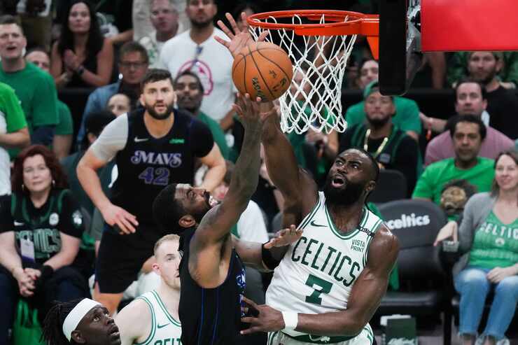 Boston Celtics guard Jaylen Brown (7) blocks a shot by Dallas Mavericks guard Kyrie Irving...