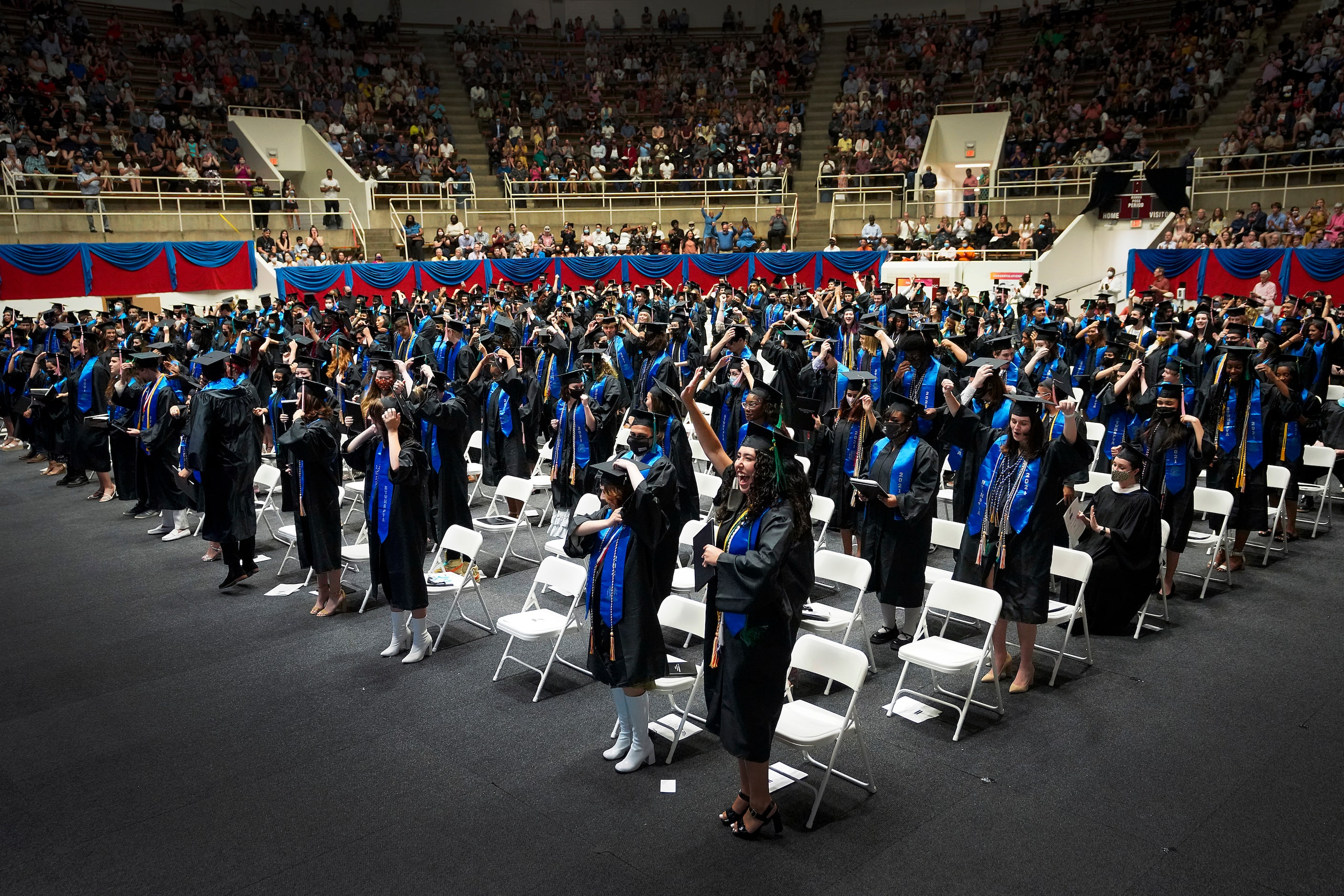 Graduates celebrate after the turning of the tassel during commencement ceremonies for...