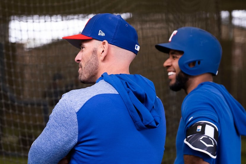 Texas Rangers manager Chris Woodward and shortstop Elvis Andrus watch batting practice...