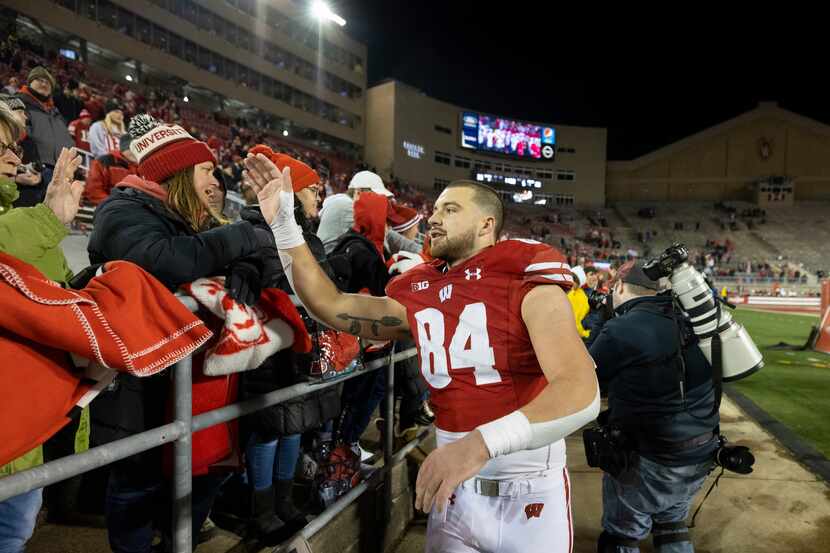Wisconsin Badgers senior tight end Jake Ferguson (84) celebrates with fans after an NCAA...