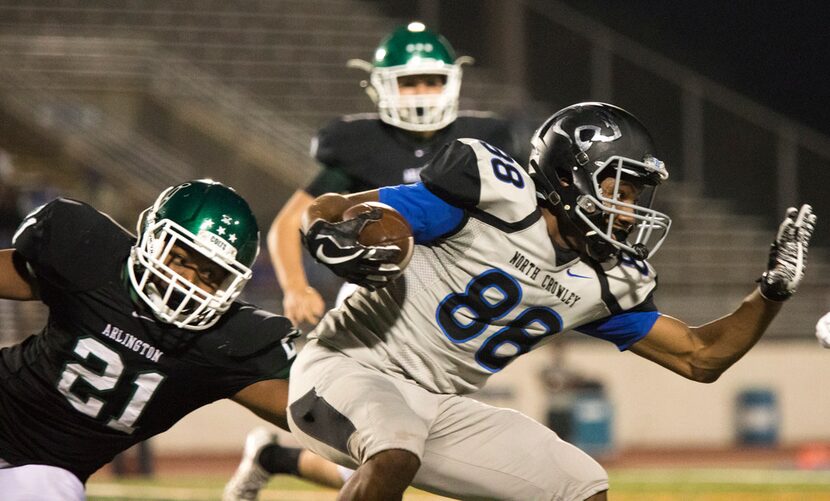 North Crowley wide receiver Chris Taylor (88) attempts to rush through the defense during a...