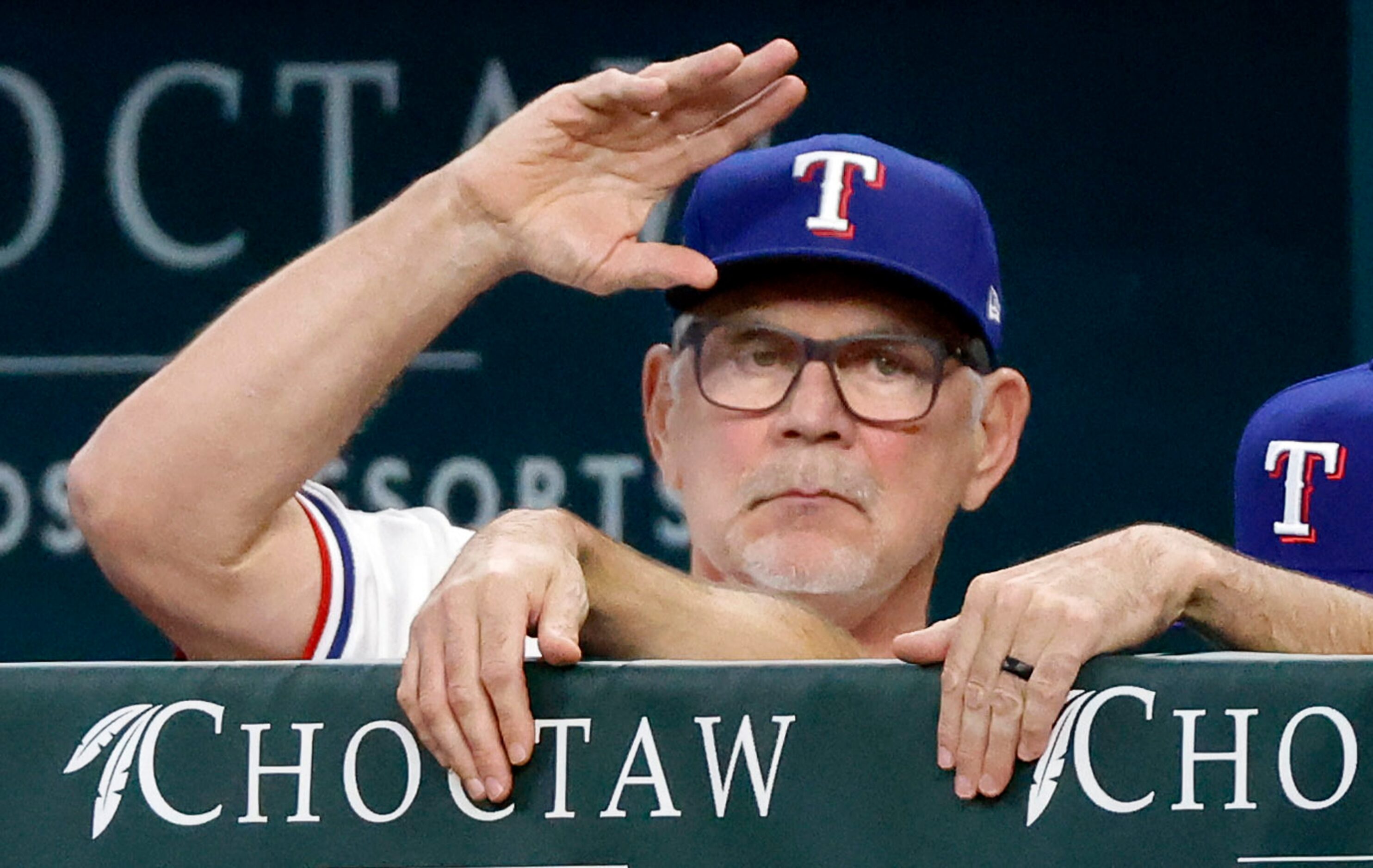 Texas Rangers manager Bruce Bochy waves to the home plate umpire before they face the...