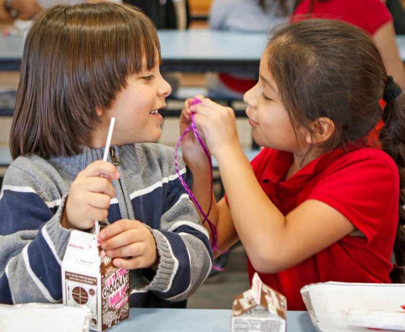 
Luis Rodriguez, 6, (left) and Sophia Reyes, 7, joke around during snack time.
