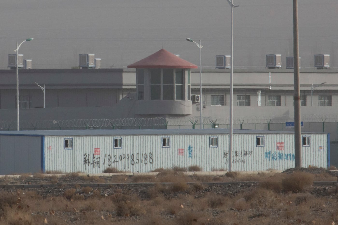 A guard tower and barbed wire fences are seen around a facility in the Kunshan Industrial...