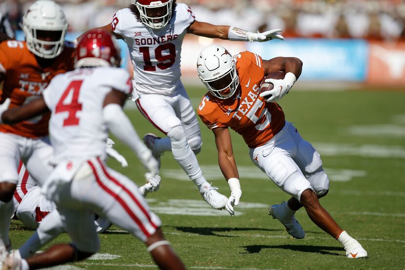 Texas running back Bijan Robinson (5) looks for room against the Oklahoma defense during the...