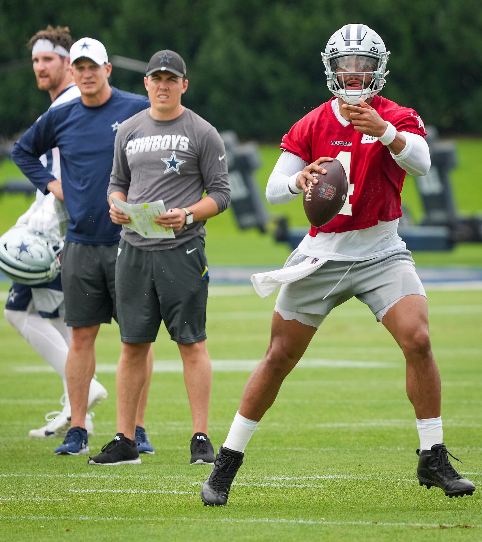 Dallas Cowboys quarterback Dak Prescott (4) runs a drill as offensive coordinator Kellen...