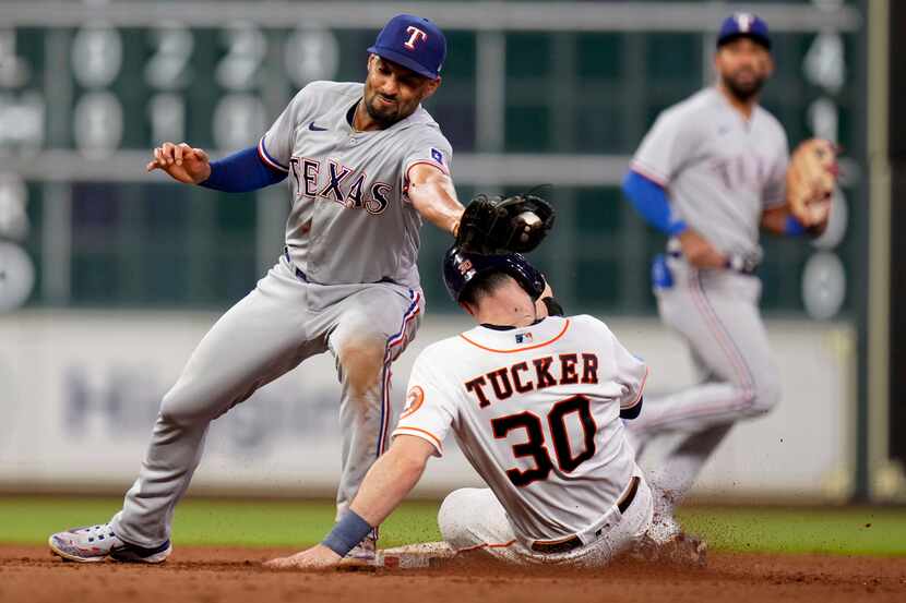 Houston Astros' Kyle Tucker (30) steals second as Texas Rangers second baseman Marcus Semien...