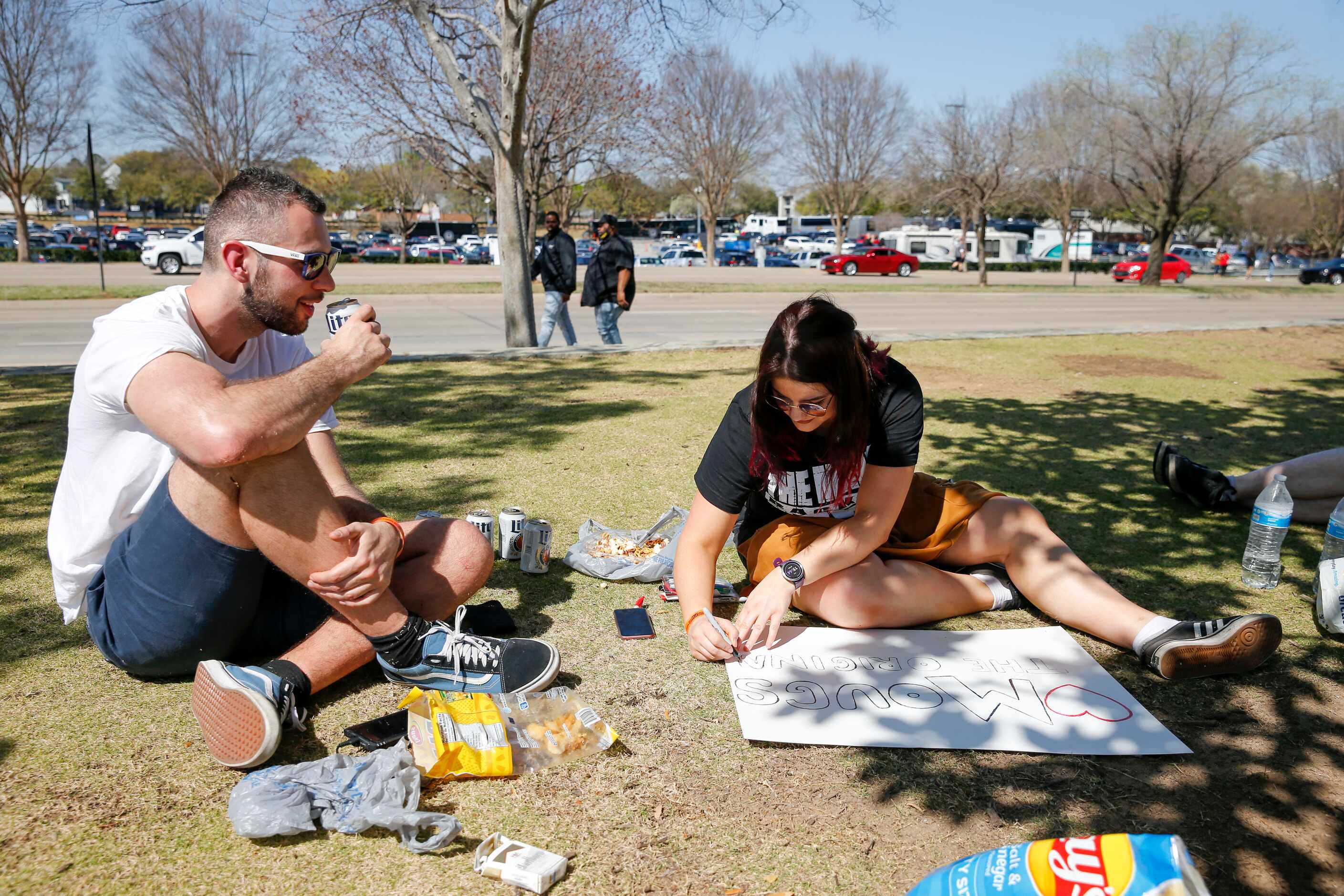 Alex Francis watches as his girlfriend Paige Will makes a sign before WrestleMania 38 at...