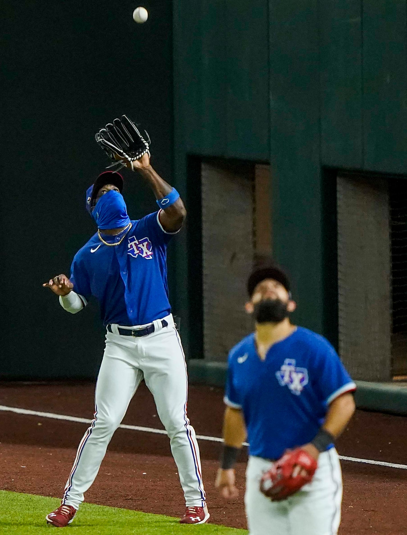 Texas Rangers outfielder Adolis Garcia makes a catch on a fly ball off the bat of Colorado...