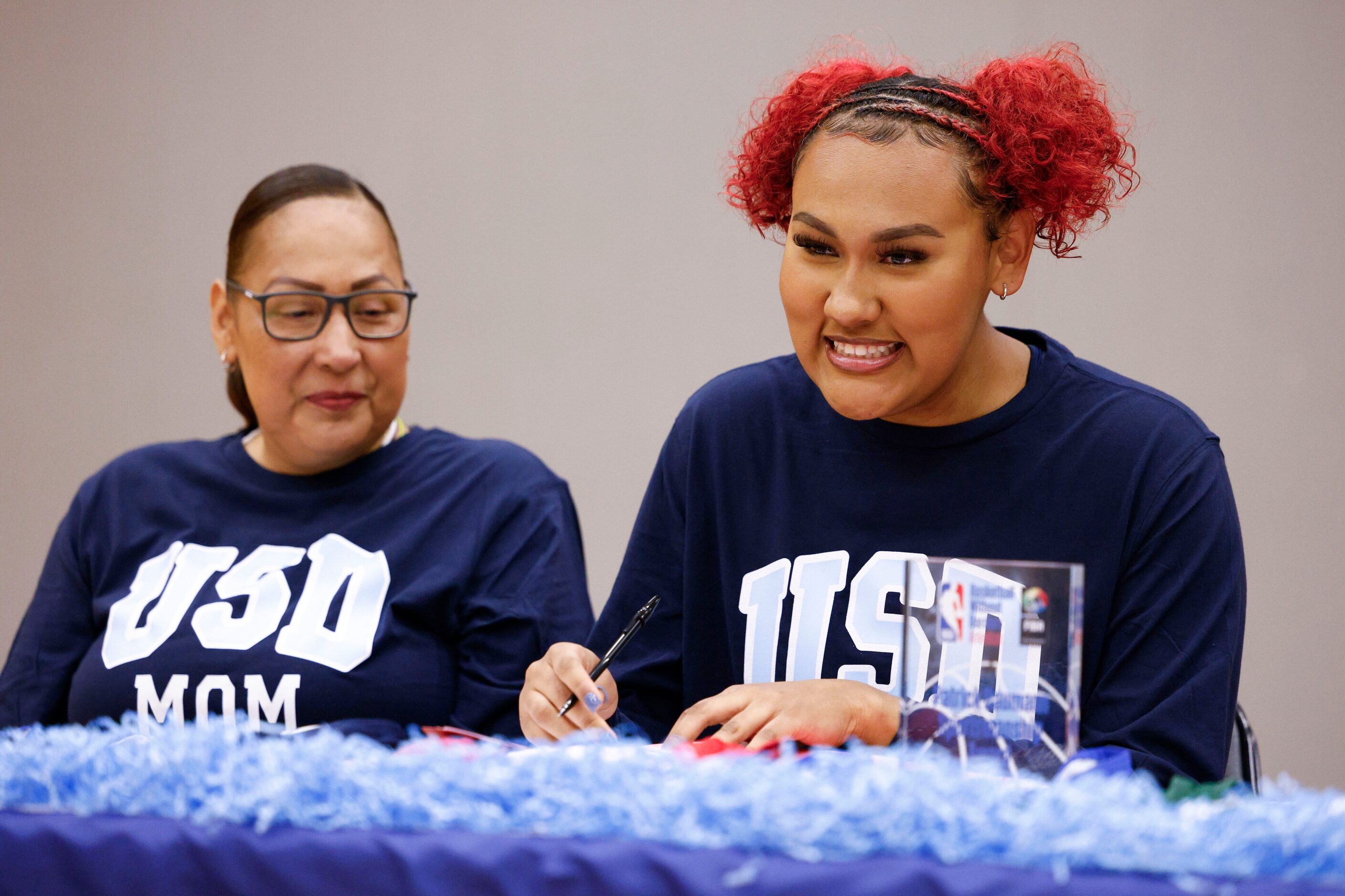 South Grand Prairie girls basketball player Erica Carr (right) signs alongside her mother...