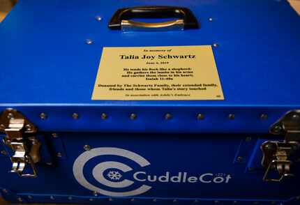 A dedication plaque in Talia Joy Schwartz's honor is posted on a CuddleCot device at Medical...