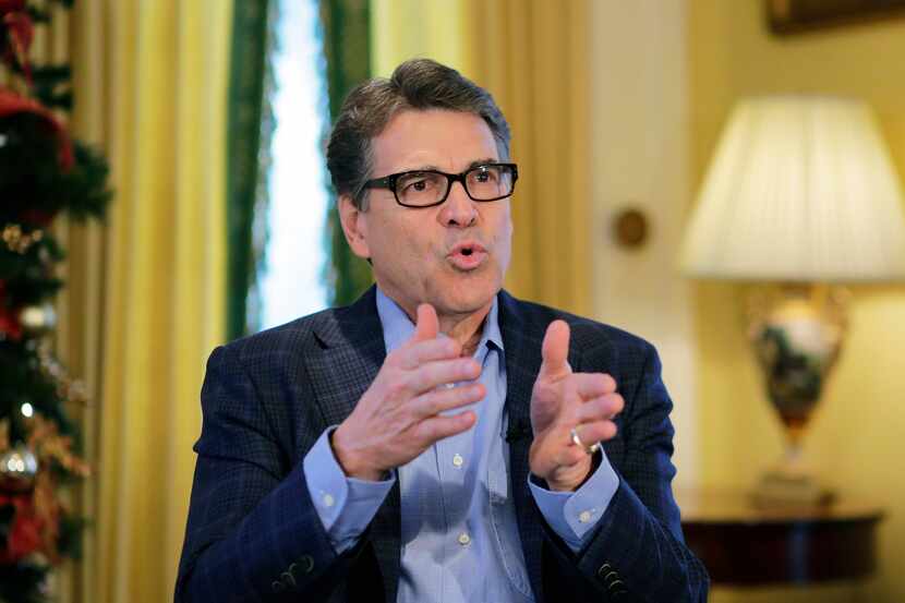 In this photo taken Dec. 9, 2014, Texas Gov. Rick Perry answers questions during an...