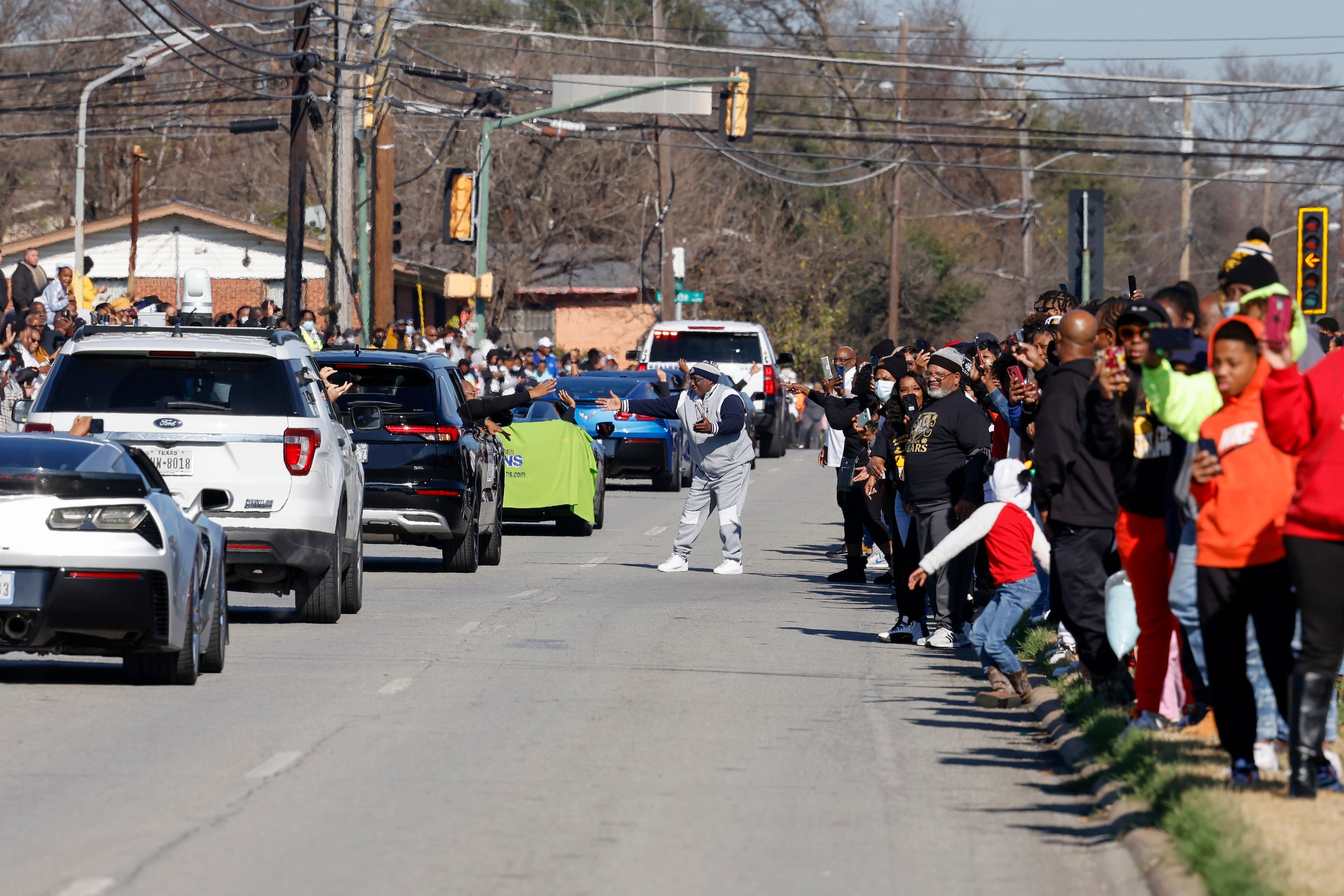 Community members and fans line Marsalis Avenue during a parade celebrating South Oak...