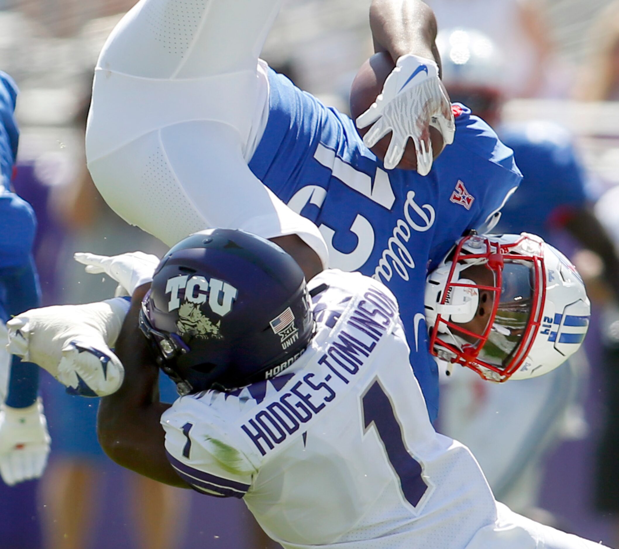 SMU receiver Roderick Daniels, Jr. (13) is upended by TCU cornerback Tri'Vius...