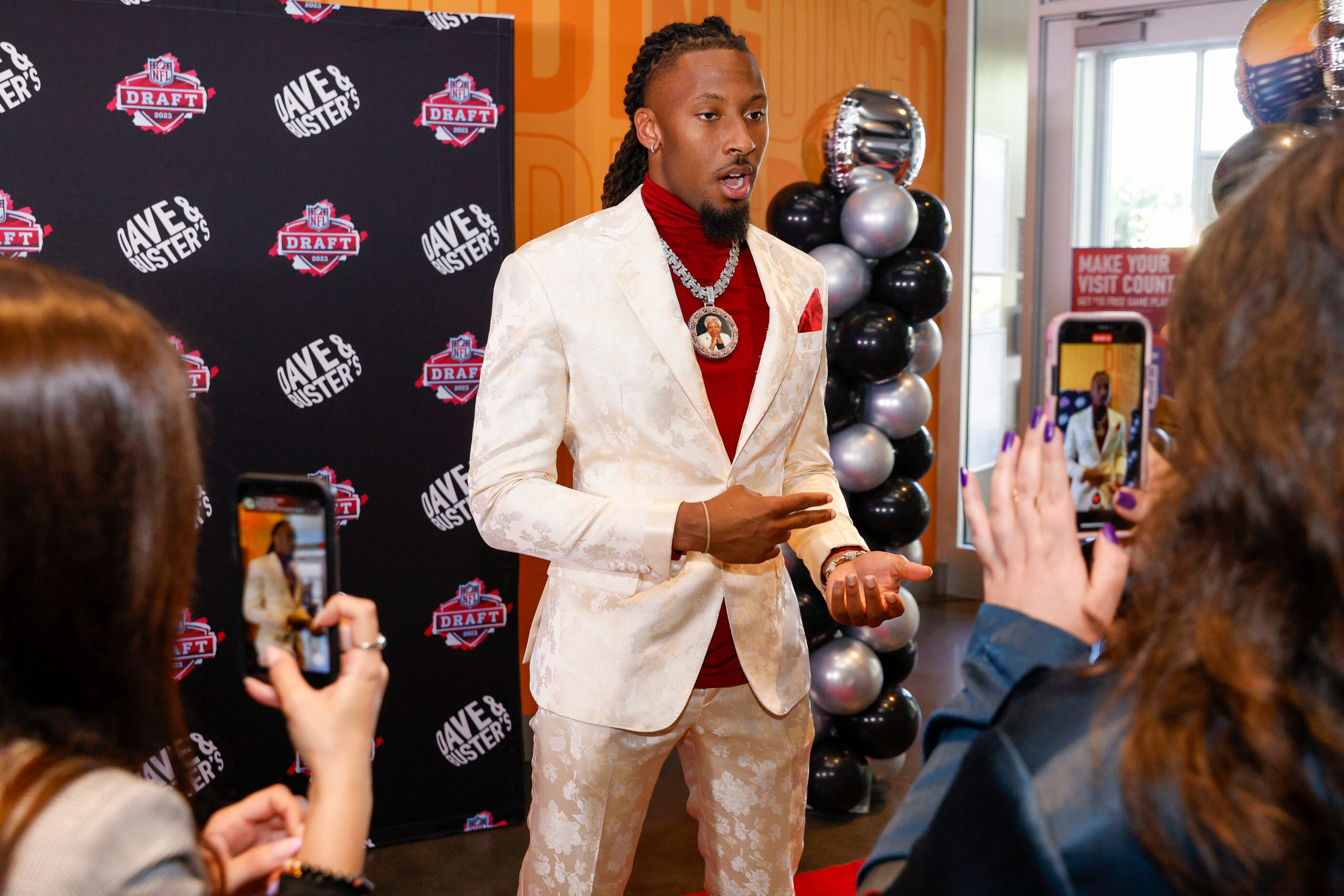 TCU wide receiver Quentin Johnston talks on the red carpet before a 2023 NFL Draft party at...