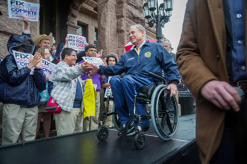 Gov. Greg Abbott makes his way to center stage  on the north steps of the Texas Capitol  to...