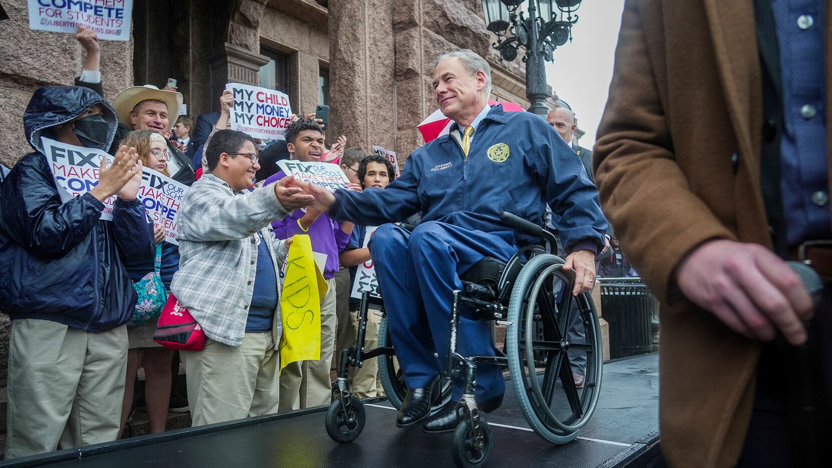 Gov. Greg Abbott makes his way to center stage to speak on the north steps of the State...