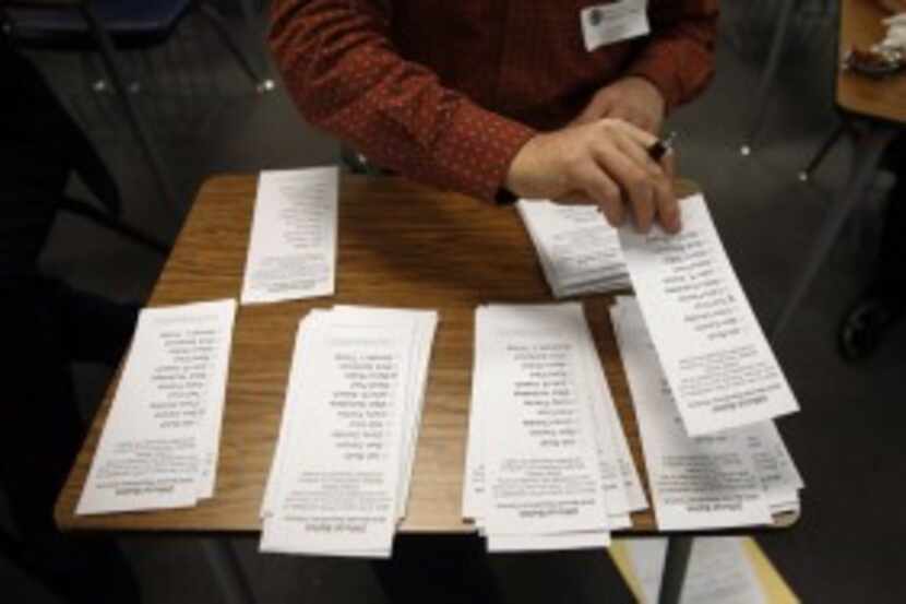  Officials count ballots at Palo Verde High School, a Republican caucus site in Las Vegas,...