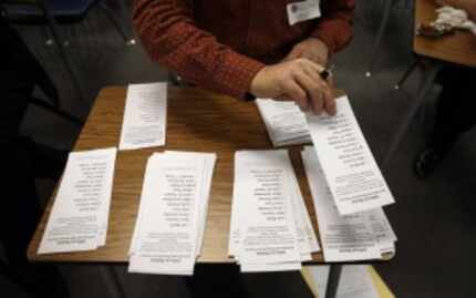  Officials count ballots at Palo Verde High School, a Republican caucus site in Las Vegas,...