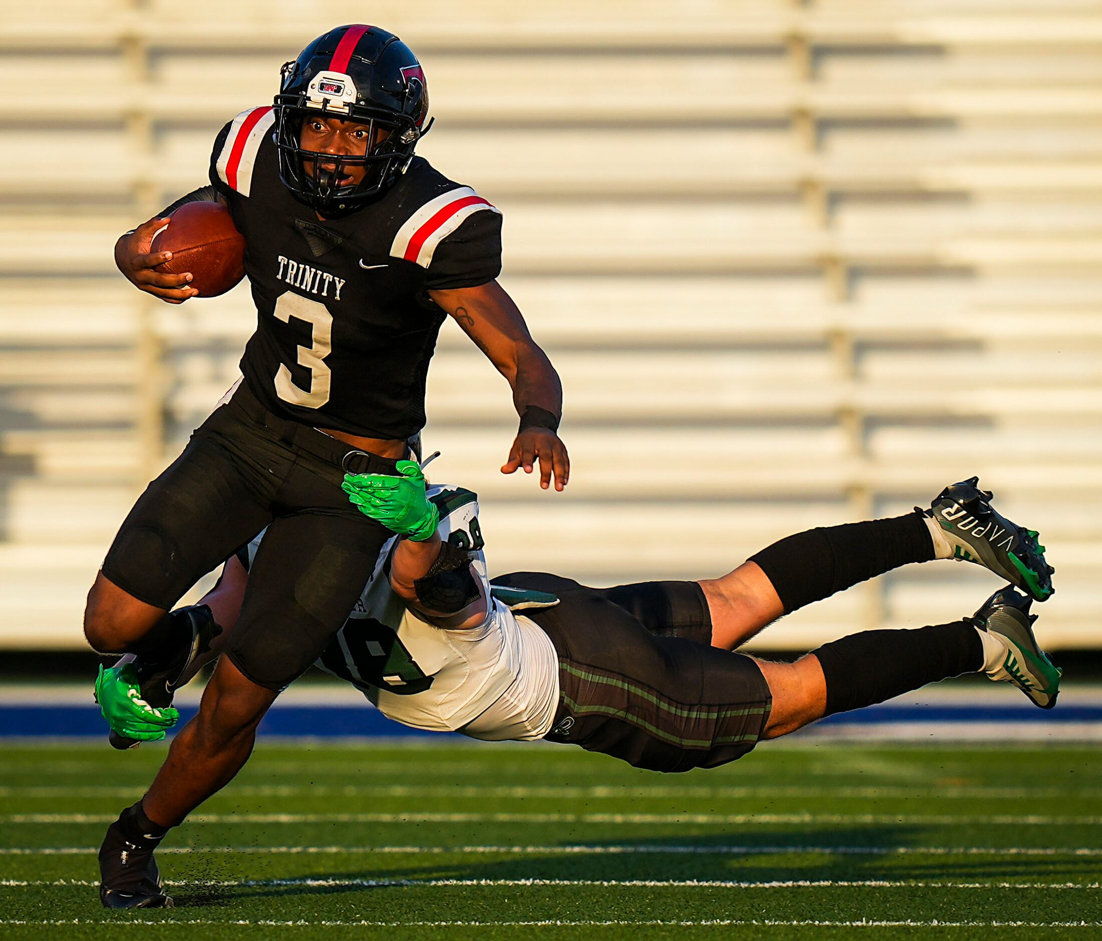 Euless Trinity running back Gary Maddox (3) tries to get around Prosper’s Jonah McClendon...