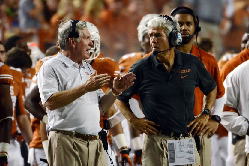 Sep 14, 2013; Austin, TX, USA; Texas Longhorns head coach Mack Brown (left) talks with...