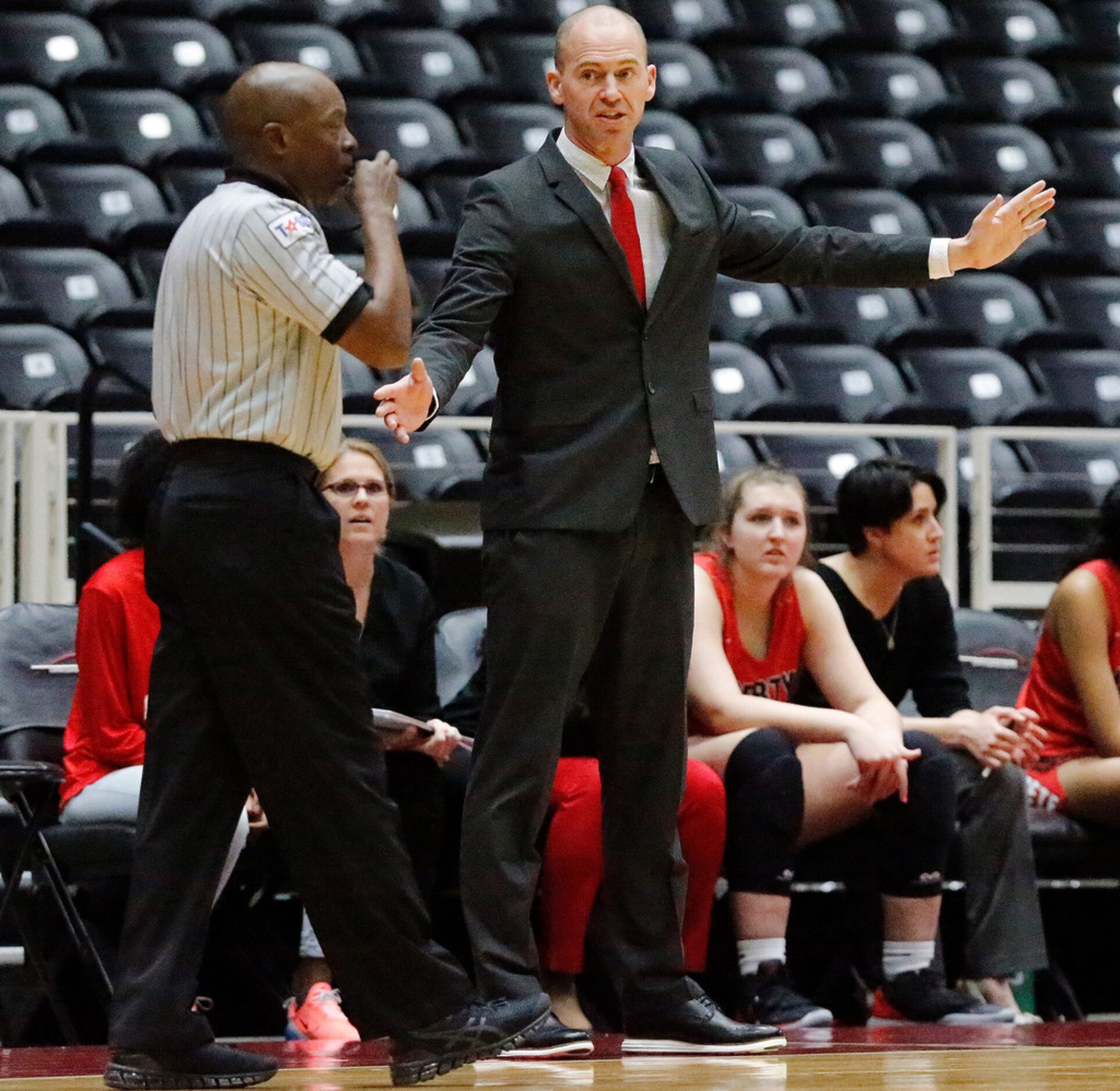 Frisco Liberty High School head coach Ross Reedy gets clarification during the first half as...