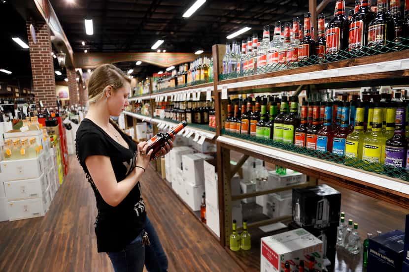 Shelly Bridwell, from Grapevine, shops at Goody Goody liquor store in Colleyville on April...