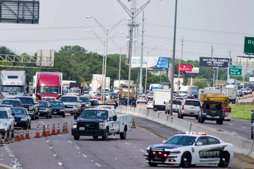 Traffic is routed off the interstate as Texas Department of Transportation employees work to...