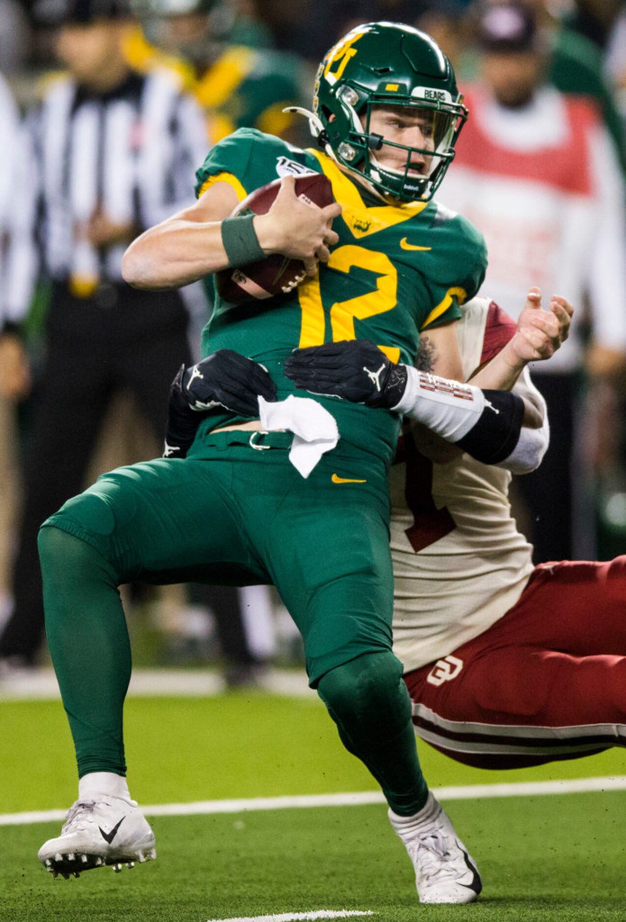 Baylor Bears quarterback Charlie Brewer (12) is sacked by Oklahoma Sooners defensive lineman...