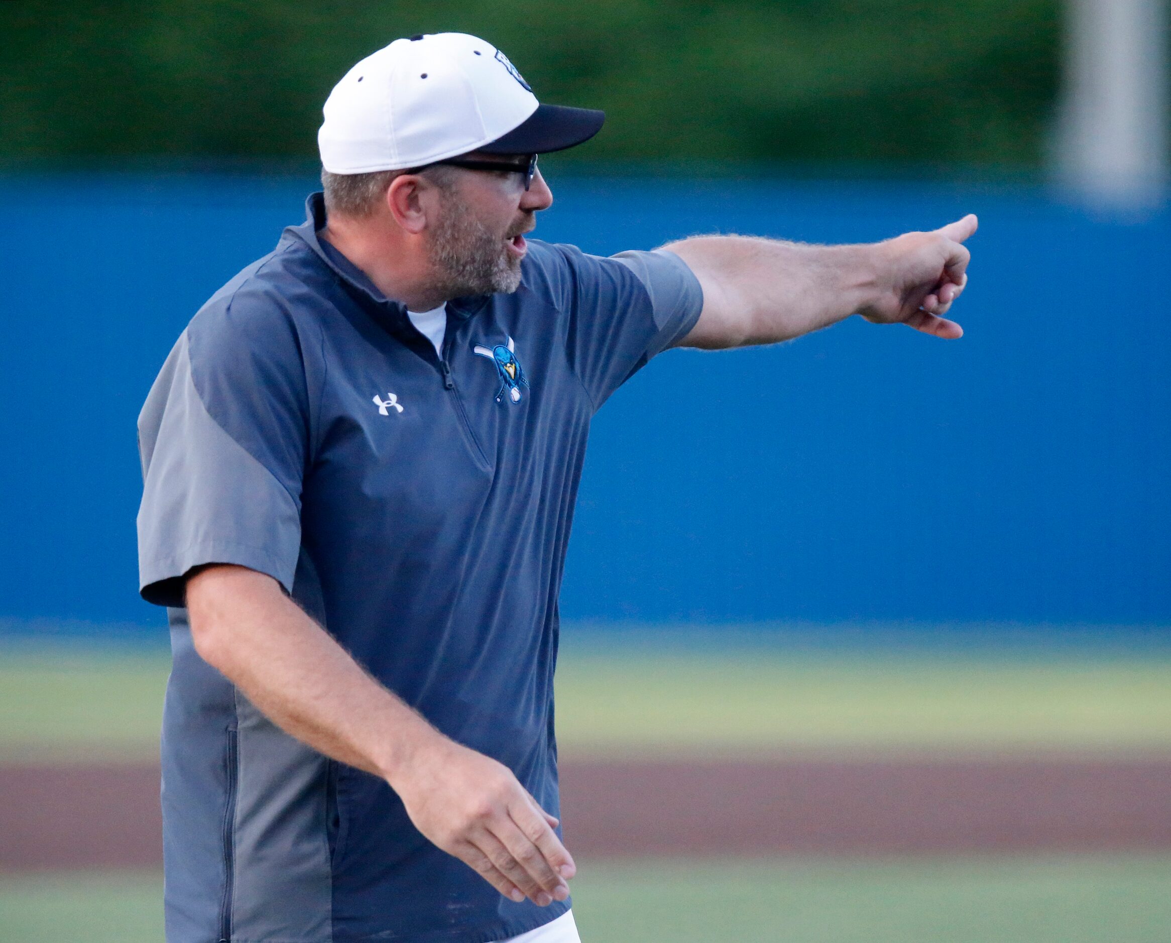 Rock Hill High School head coach Shaun Stanton challenges a safe call at home plate and the...