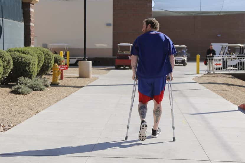 Texas Rangers' Josh Hamilton walks back after he talked about his knee injury and stem cell...